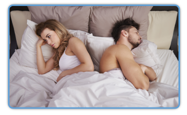 couple frustrated laying in bed back to back